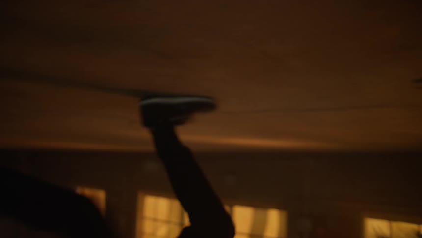 A ball rolling on a floor is scooped up