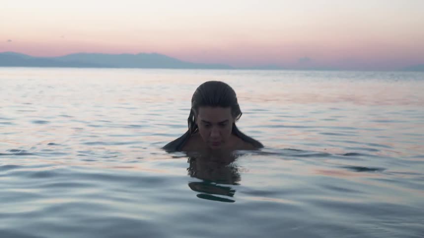 A woman is neck deep in the water