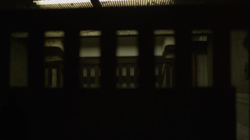 An elevator slowly rises with people inside