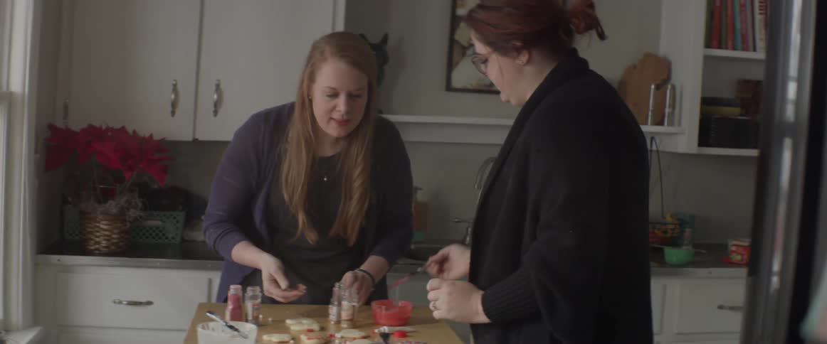 Two women are making cookies in the kitchen