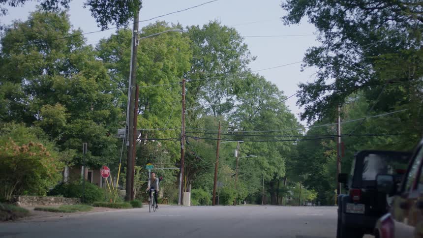 A person is riding their bicycle down the street