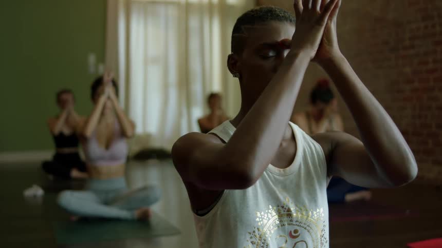 Men and women practicing yoga in a studio
