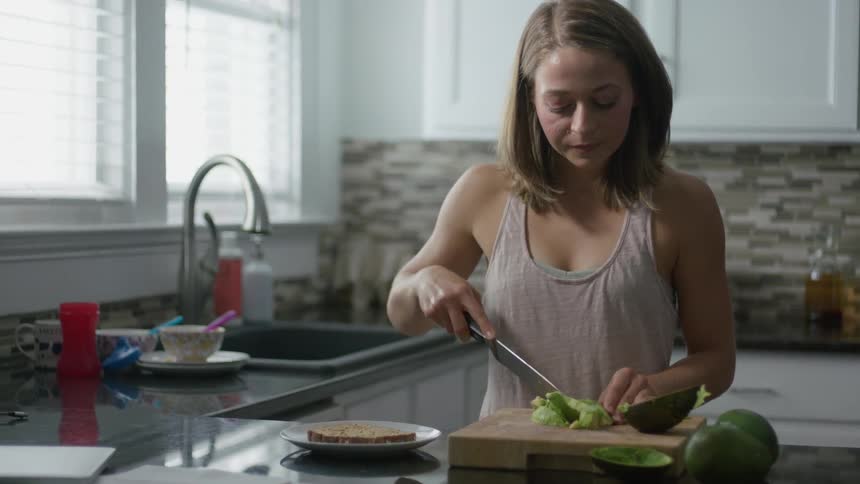 A woman is preparing food in the kitchen