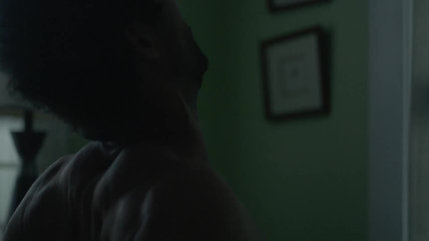 A man rubs his shoulders and stretches