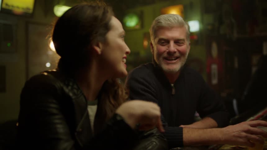 A group of people talking in a bar