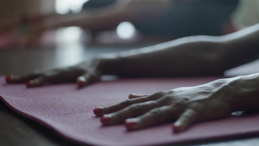 Women pose on yoga mats