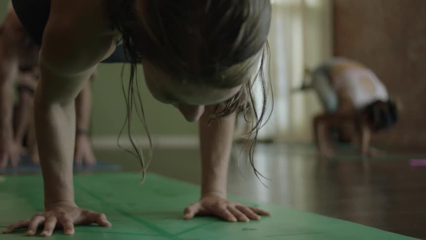 A group of women stretch and do yoga