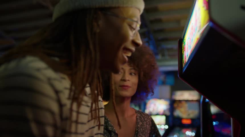 A man and woman have fun in an arcade