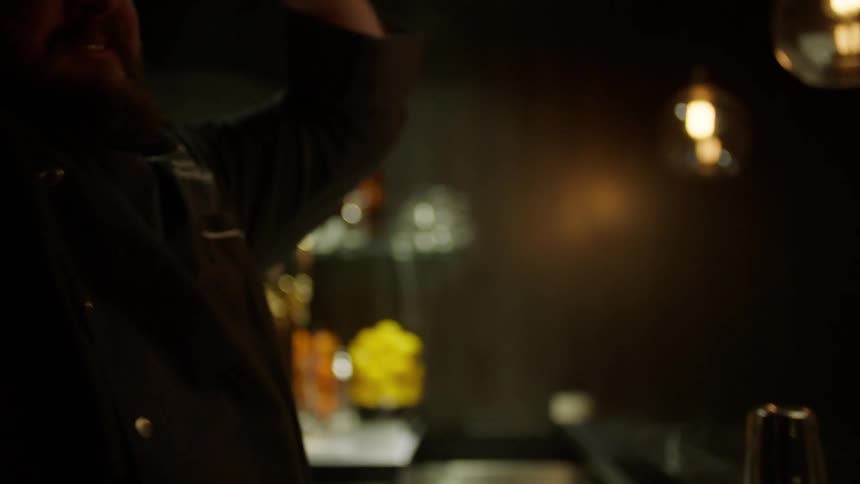 A bartender is preparing a drink