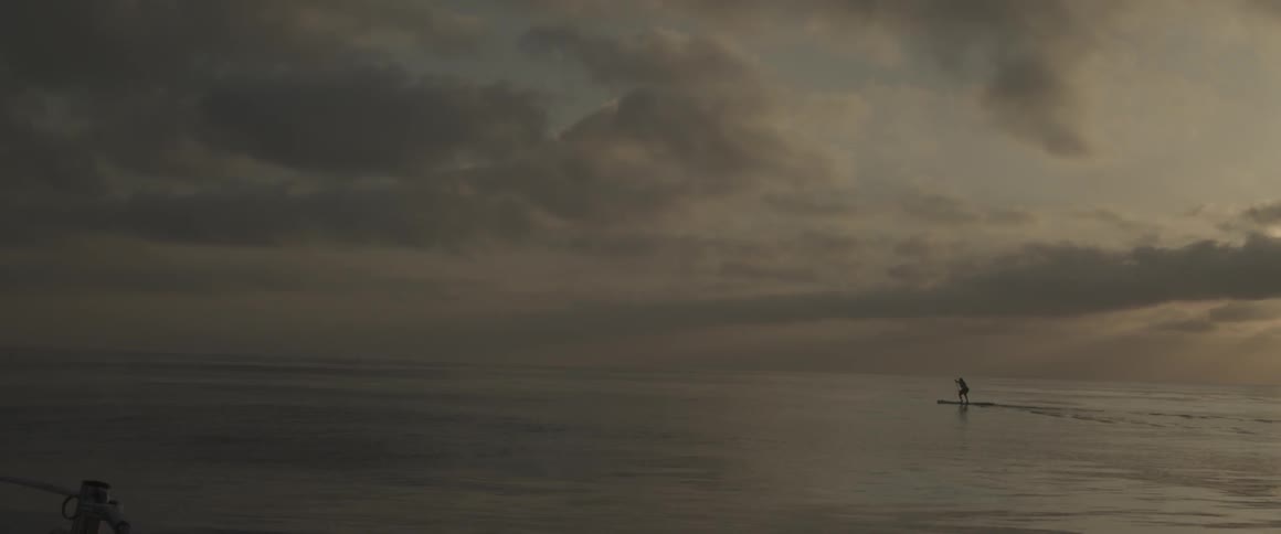 A man paddles across a large body of water