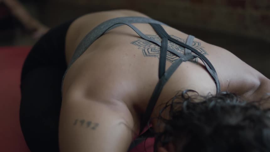 Woman stretches on a yoga mat