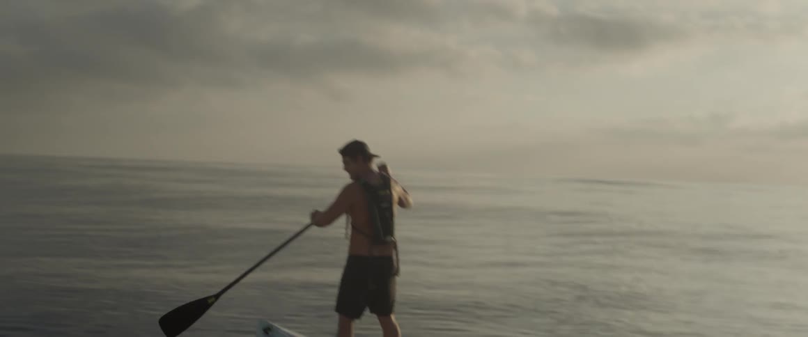 A man is rowing on a canoe in the water