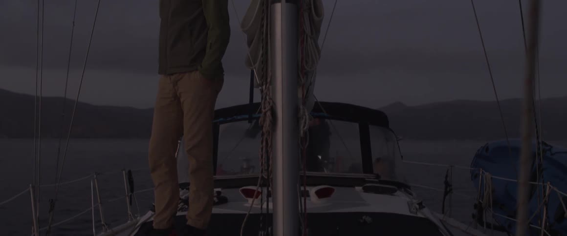 A man stands on a boat looking out into the distance