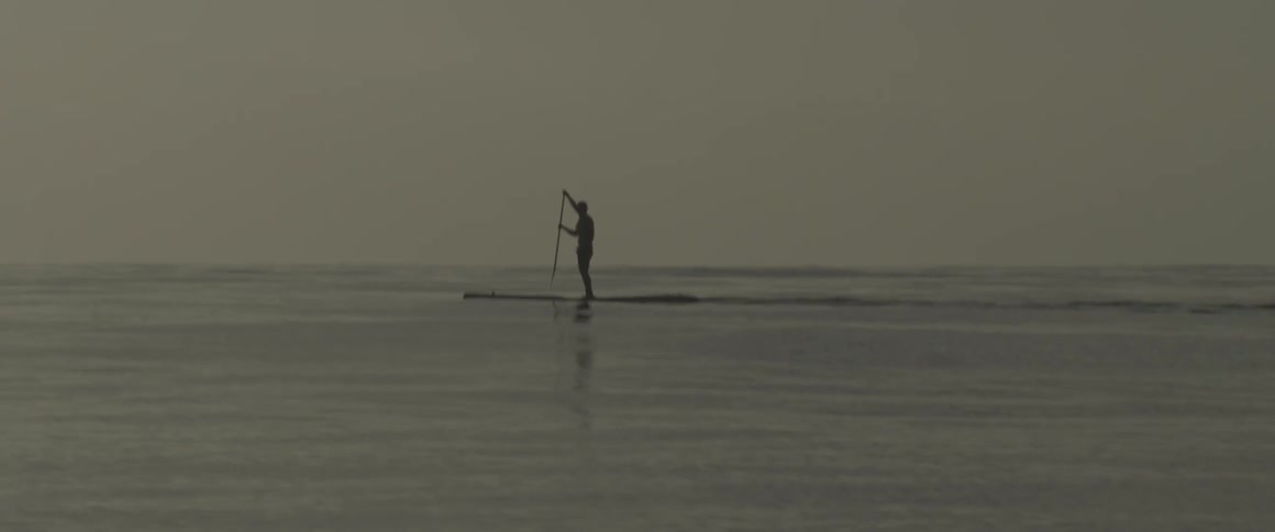 A man paddle boards on the ocean