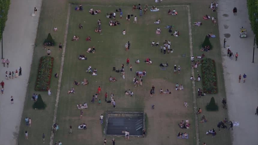 People sit and walk in a park