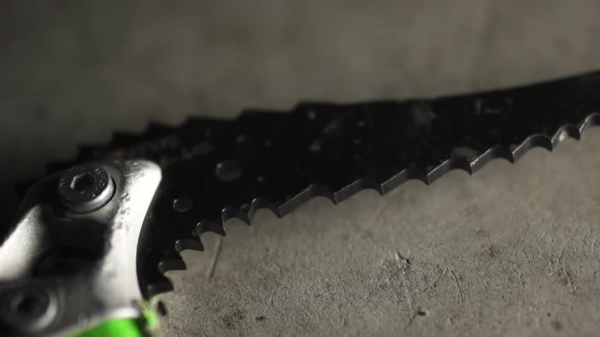 An ice climbing tool has a serrated edge.