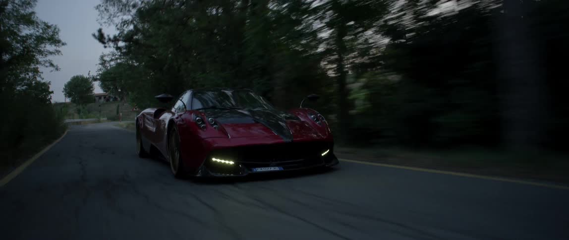 Car speeds along a curve on a country road