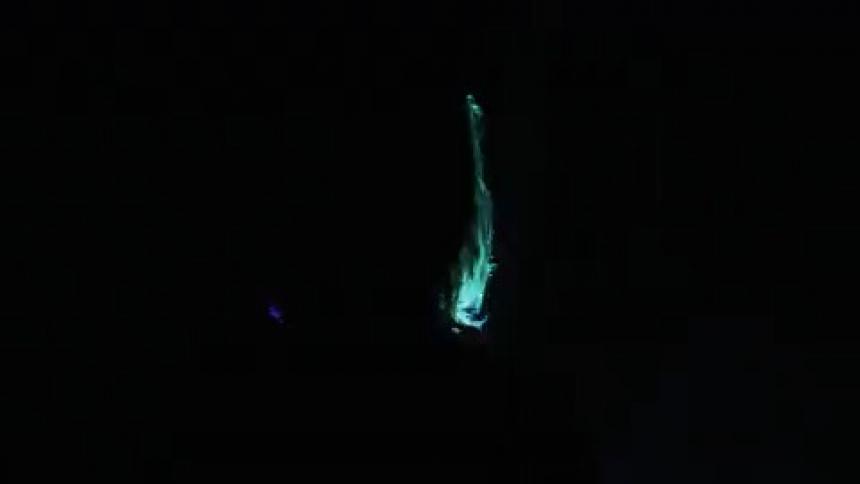 Lights are illuminating the figure of a man