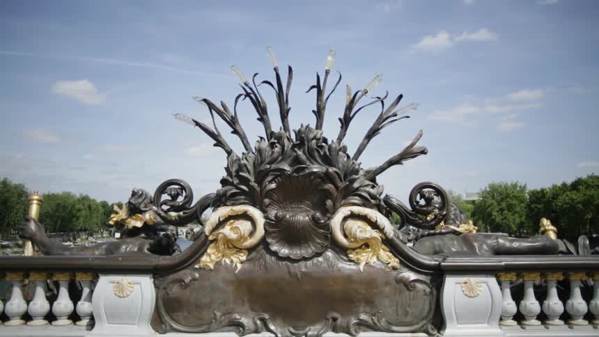 A large statue has a railing on either side