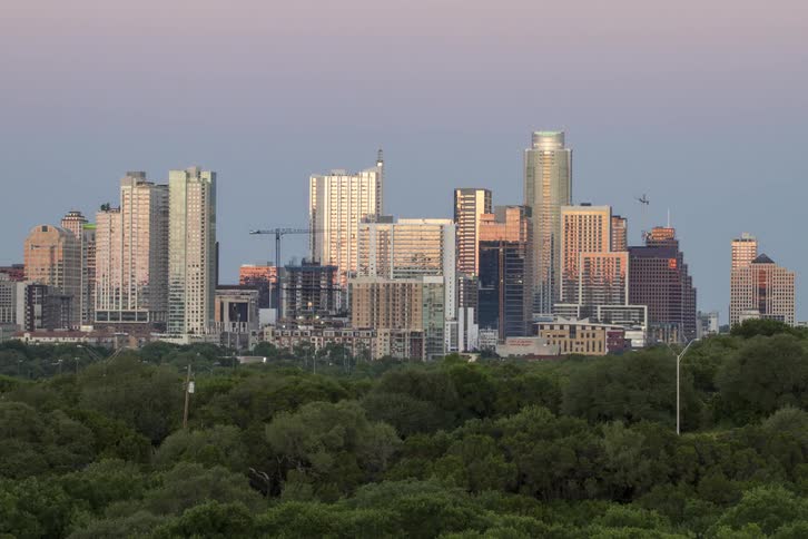City lights turn on as the day fades to night