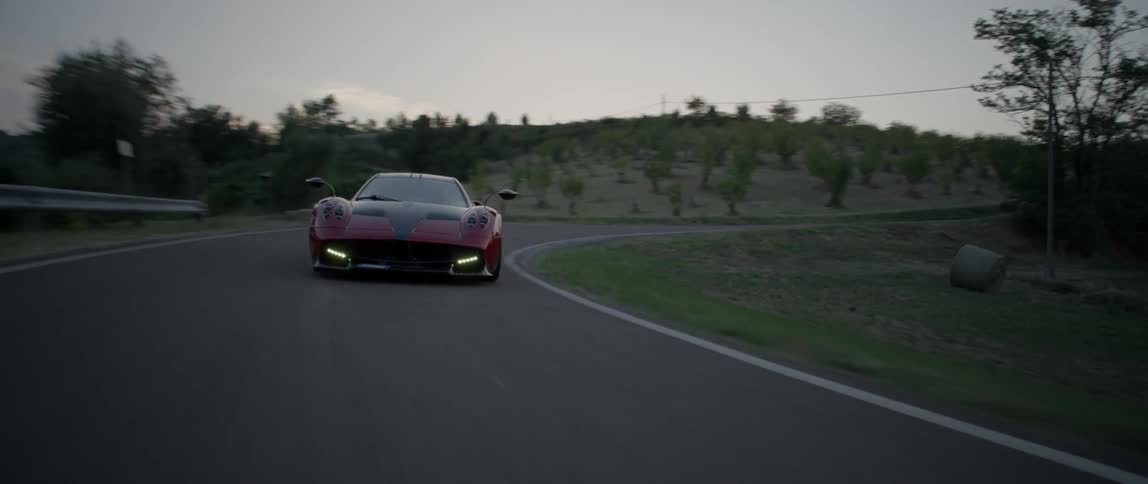 A sports car speeds around a curve