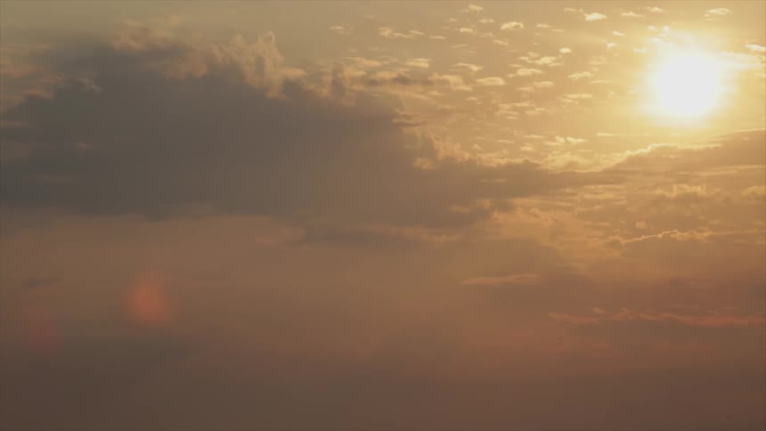 The sun casts an orange glow in the sky