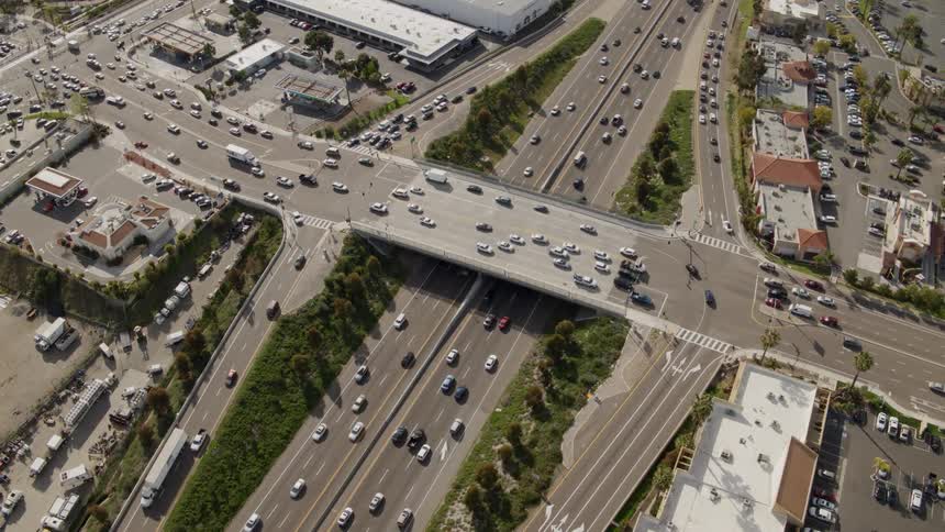 Cars drive on a city highway intersection