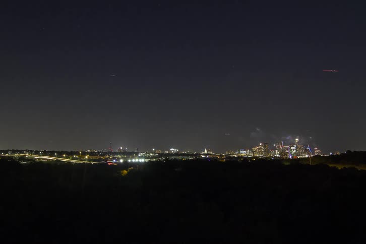 A fireworks display lights up a city skyline in timelapse