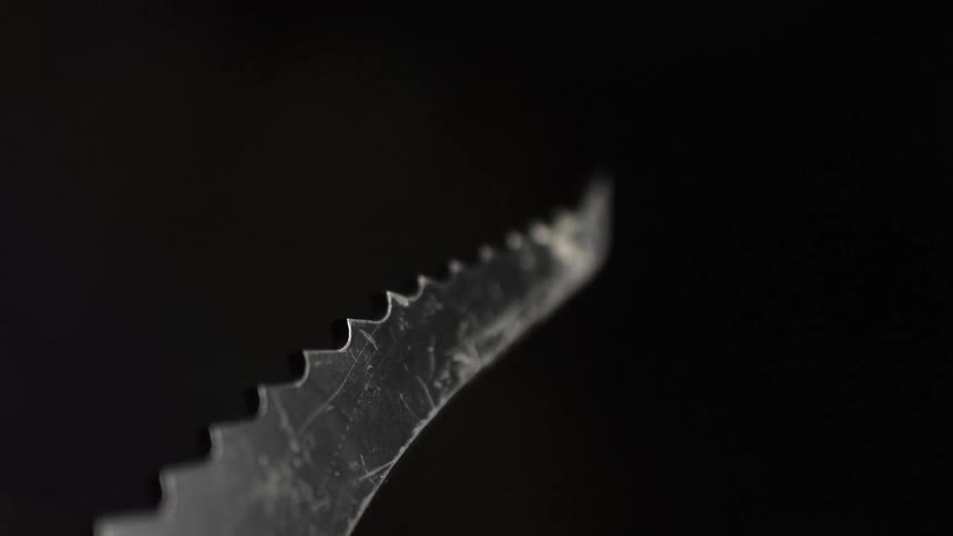A jagged knife blade holds up into the air