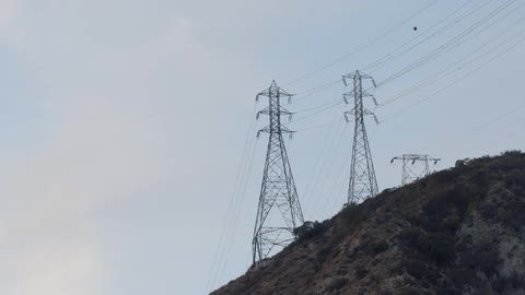 The large power lines are on the hill top