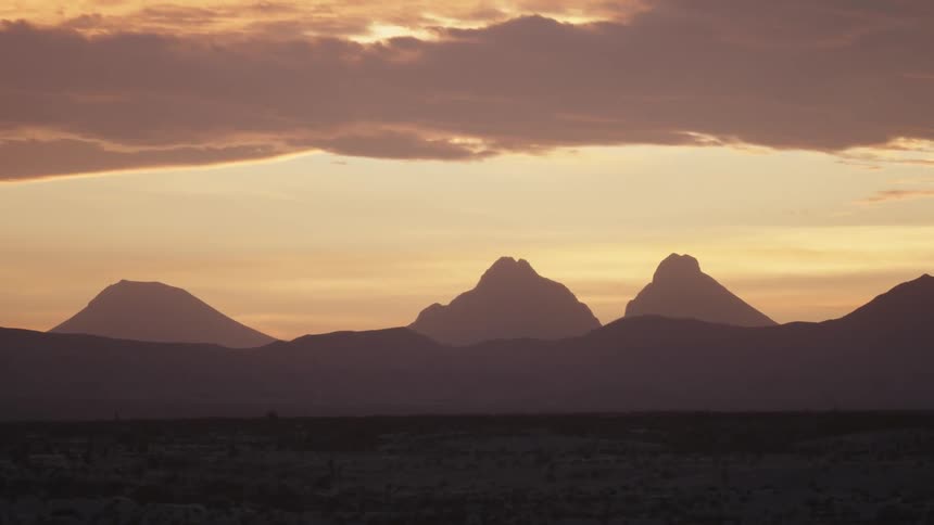 The field is barren ahead leading to mountains