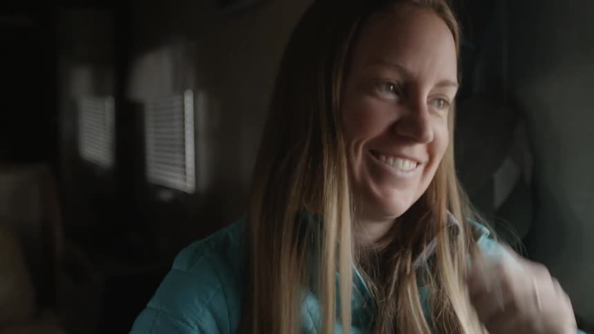 A woman smiles as she talks