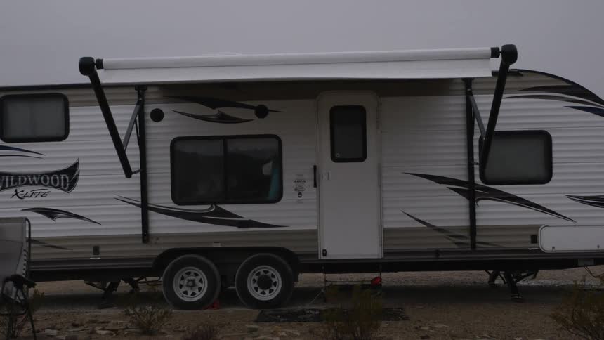 The caravan door is closed on a cloudy day