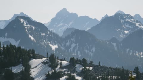 The tall mountains ahead are covered with snow