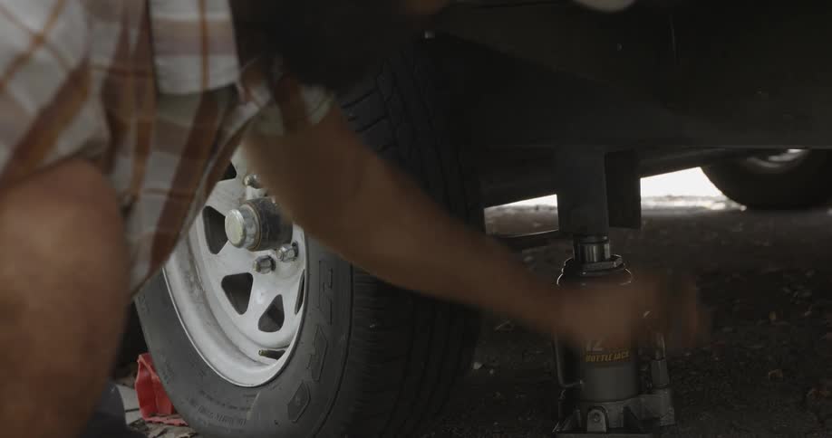 A man jacks up a car