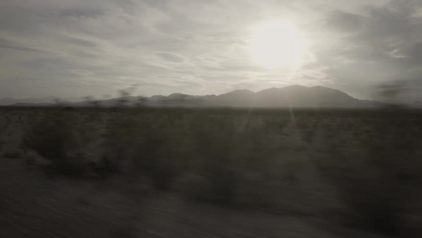 The sun shines over mountains in the wilderness