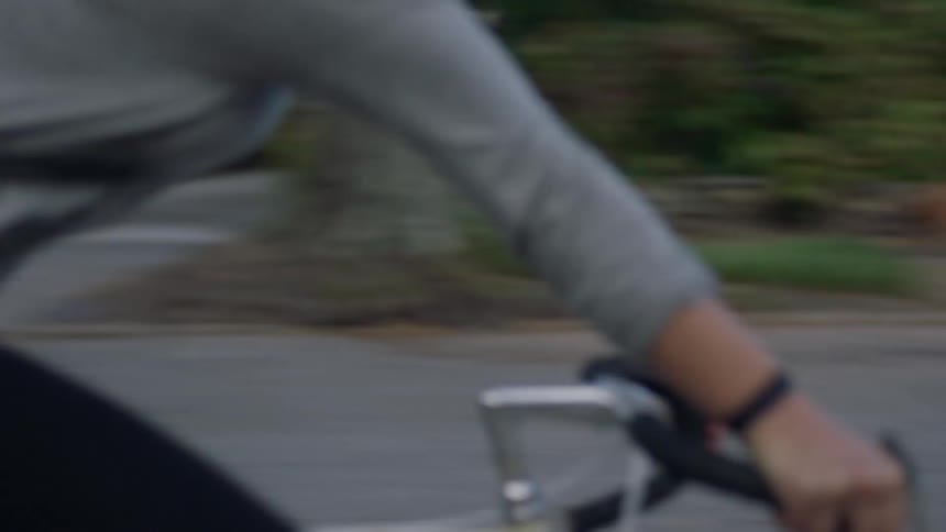 A woman is riding her bike down the empty street
