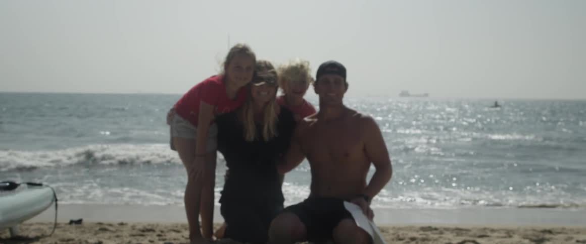 People pose on the beach for a picture