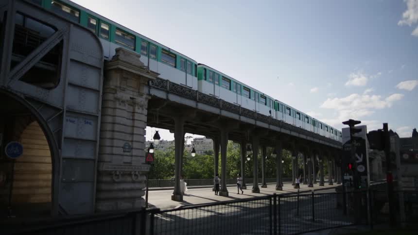 A train travels across the raised tracks