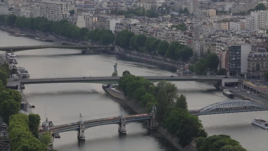 Cars drive over river bridges in a city