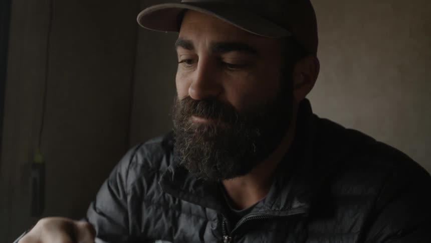 A man drinks from a mug