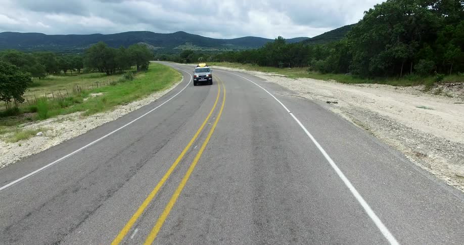 A vehicle turns around the road traveling