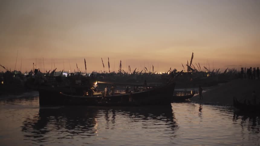 Boats float in the water near ruins