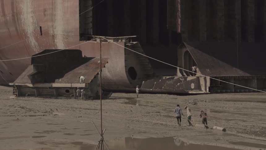 People drag items towards a barge