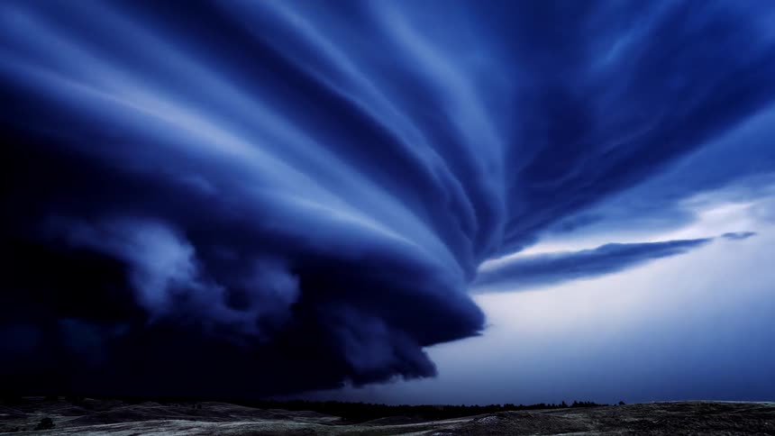 A large storm swirls and is blue as lightning flashes all over