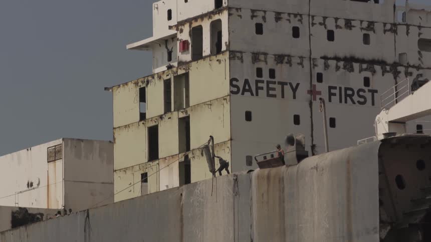 Person lifts an object onto a rooftop