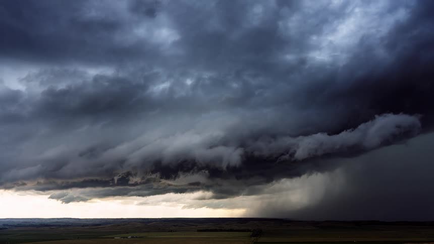 Large storm cloud forming and flowing in circular motion and pouring rain