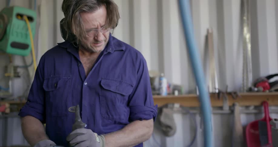 A man works with tools in a workshop