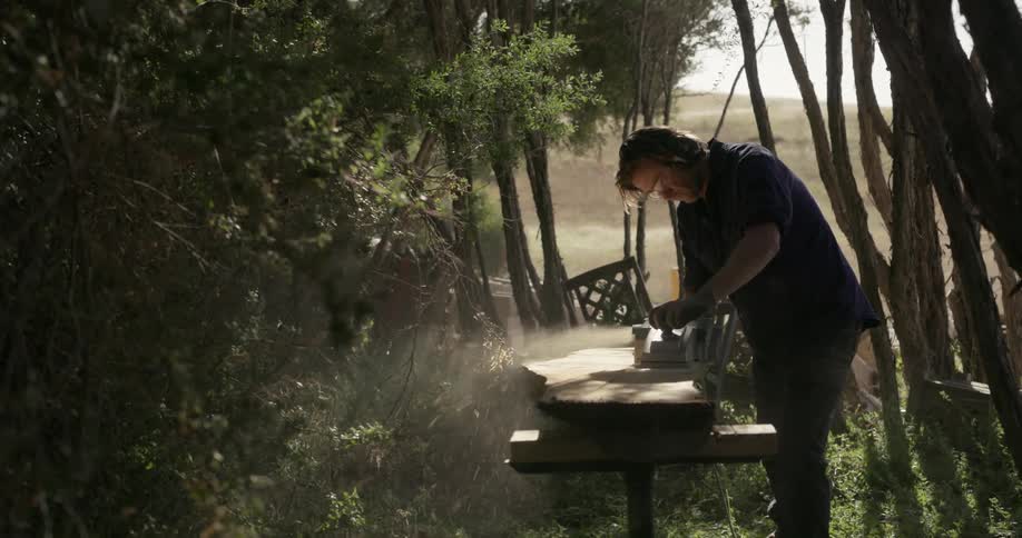 A man saws a piece of wood