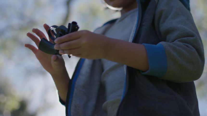 A girl picks up a gun from the ground